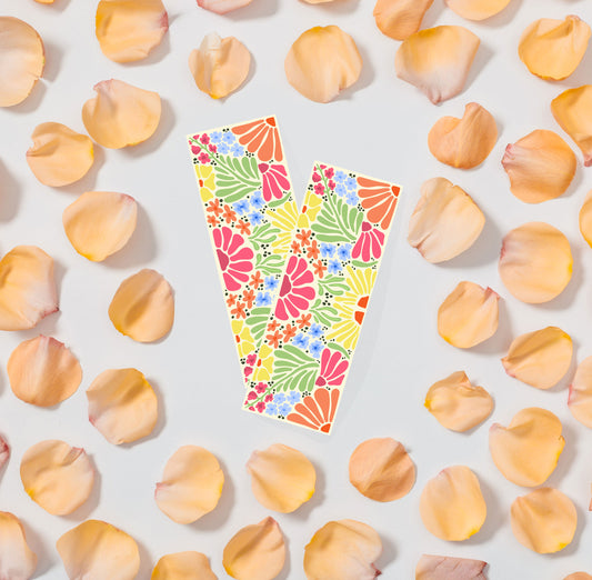 Colorful floral patterned bookmark on a light background with scattered flower petals