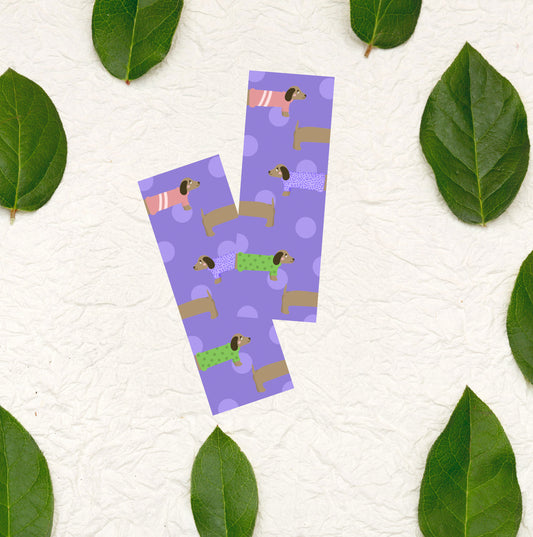Cute purple bookmark with dogs wearing colorful sweaters on it
